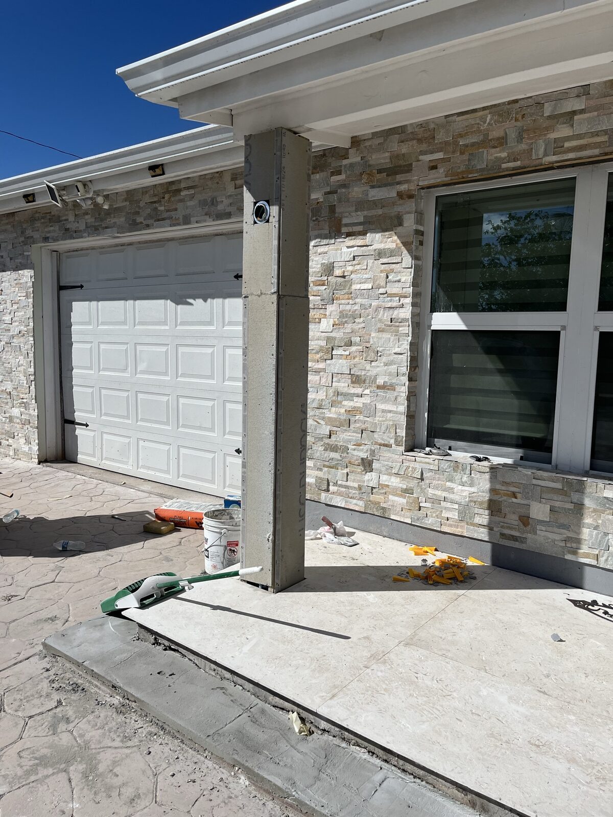 Residential exterior stone veneer renovation with impact windows, Miami-Dade