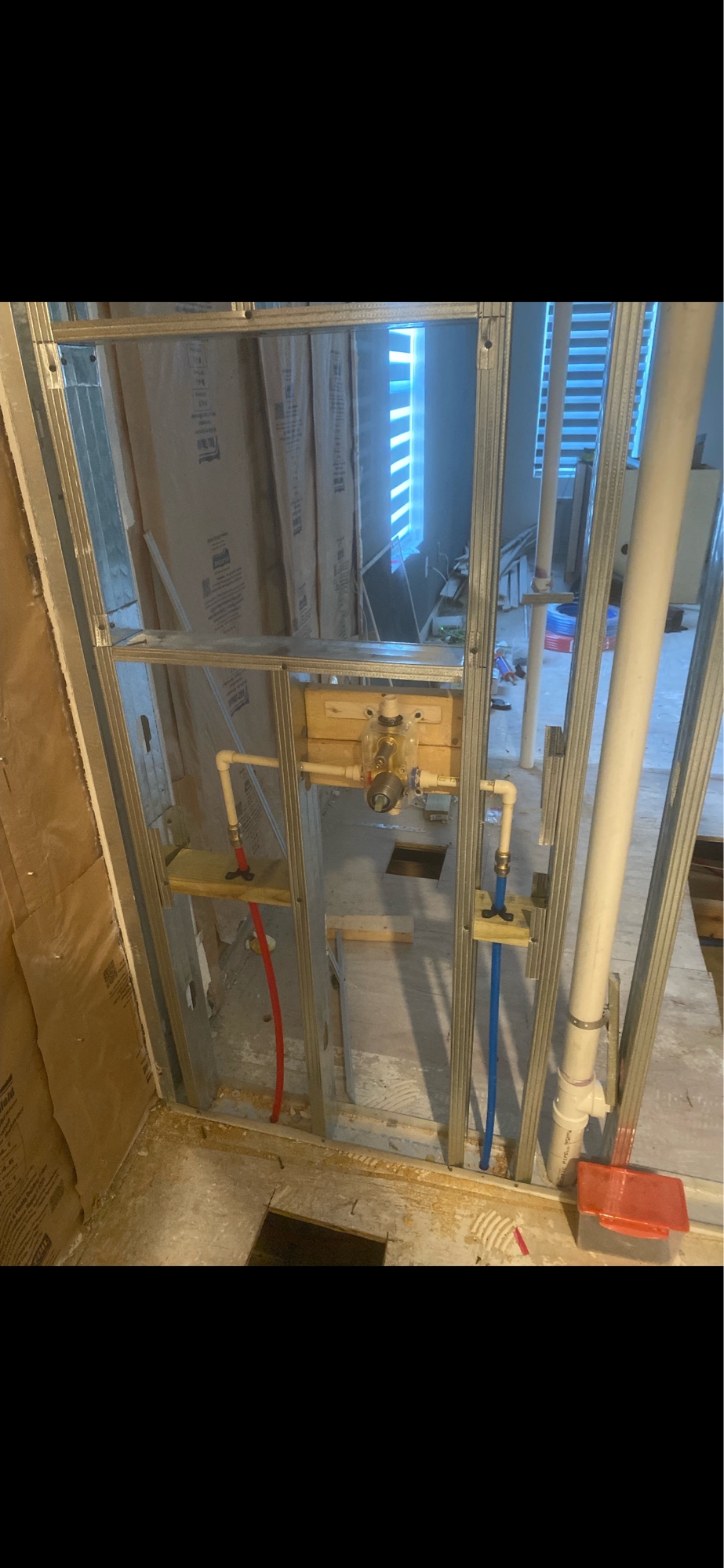 Shower plumbing rough-in with PEX water lines and valve blocking